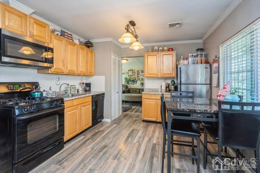 121 Winthrop Road Edison, NJ 08817 - Photo 2 of 16 a kitchen with granite countertop wooden floors sink stove and white stainless steel appliances