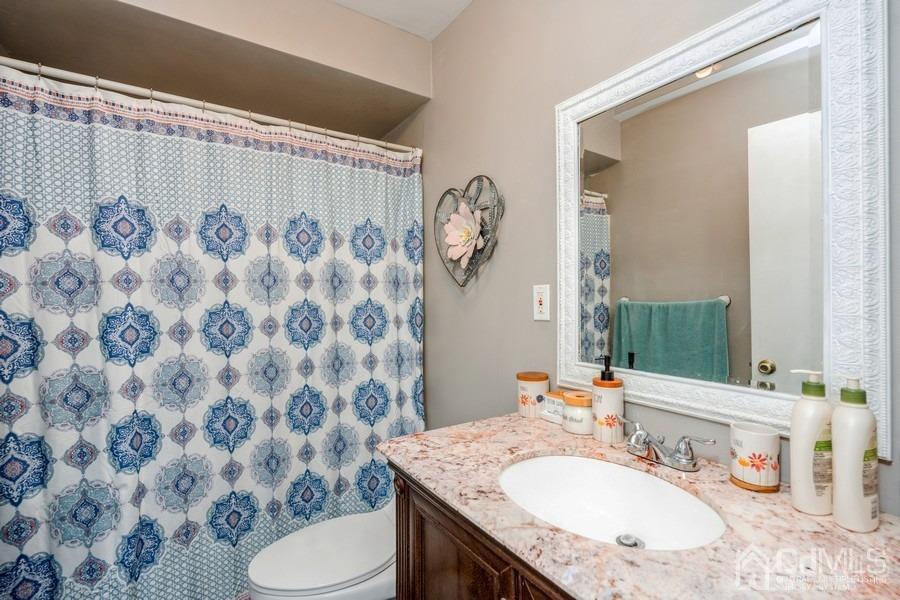 121 Winthrop Road Edison, NJ 08817 - Photo 6 of 16 a bathroom with a granite countertop sink and a mirror