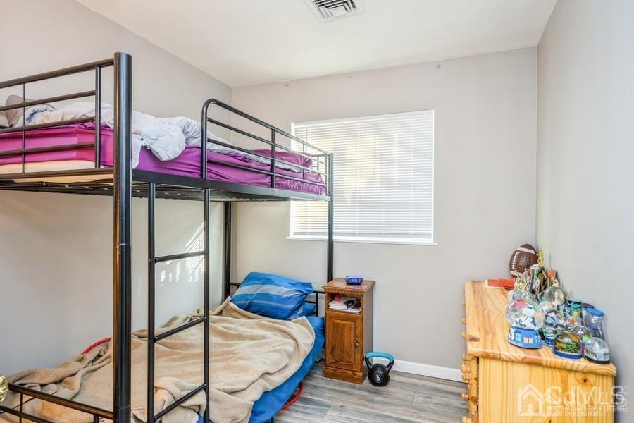 121 Winthrop Road Edison, NJ 08817 - Photo 7 of 16 a bedroom with a bed and wooden floor