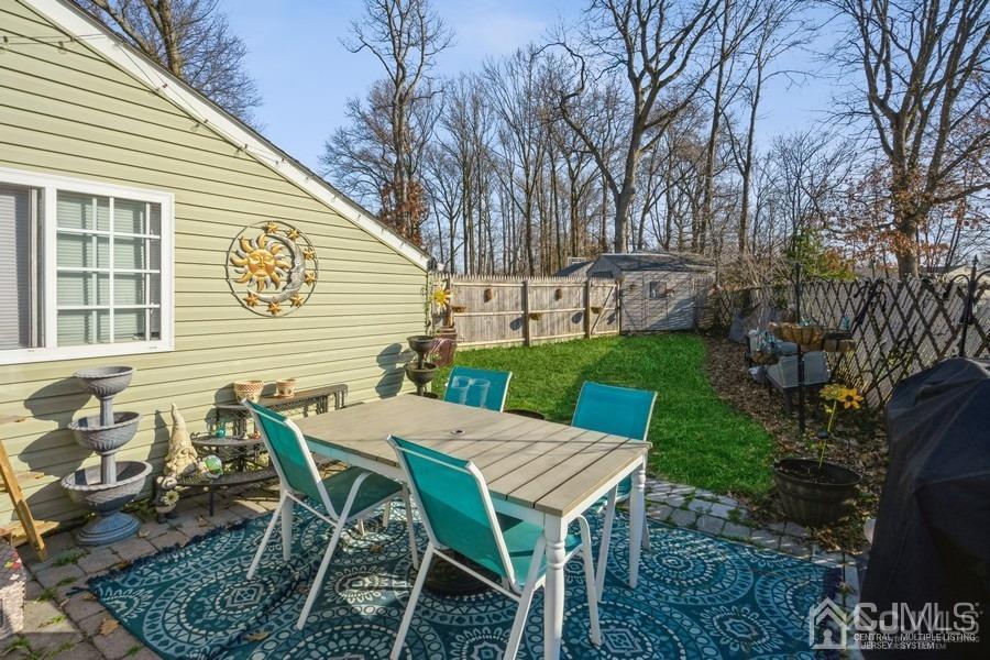 121 Winthrop Road Edison, NJ 08817 - Photo 8 of 16 a view of a patio with table and chairs with wooden floor and fence