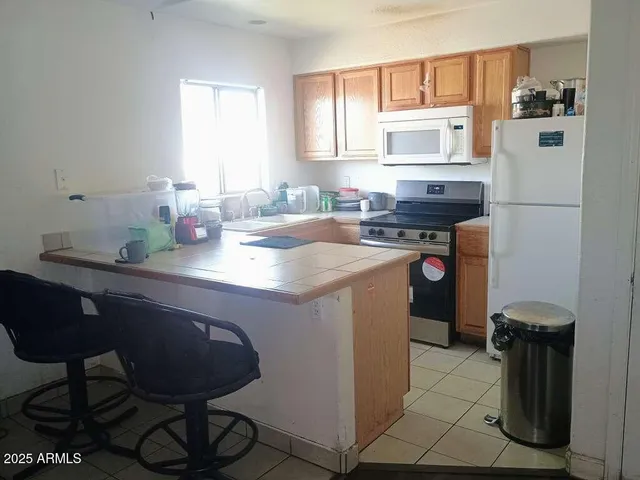 a kitchen with a sink cabinets and window