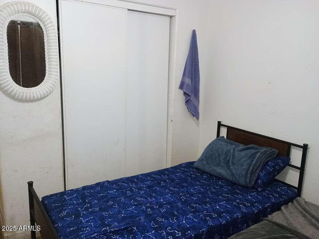 1748 West Sherman Street Phoenix, AZ 85007 - Photo 10 of 15 a bedroom with a bed and a window