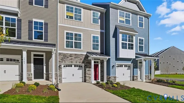 a front view of a building with a garden and plants