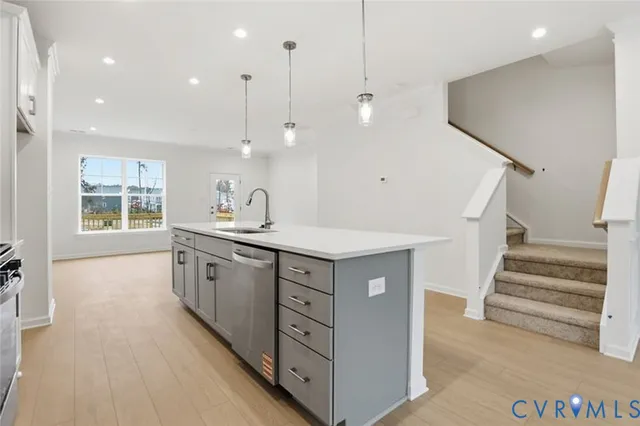 a view of a kitchen with a sink and a refrigerator
