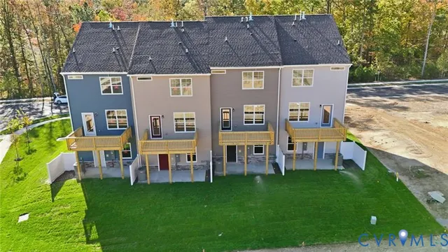 an aerial view of a house with swimming pool garden and patio