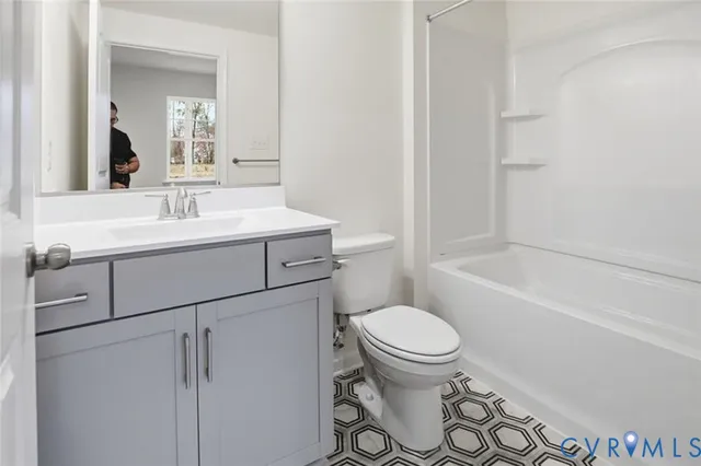 a kitchen with kitchen island a stove a sink a refrigerator and a wooden floor