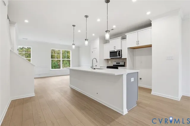 a large white kitchen with a large window