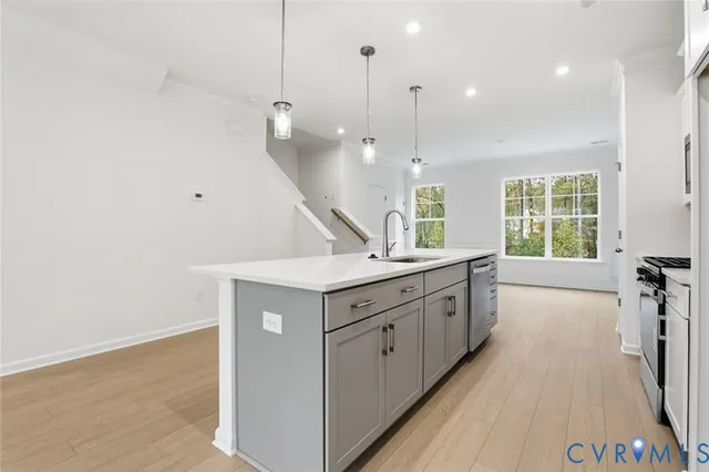 a kitchen with kitchen island a sink stainless steel appliances and cabinets