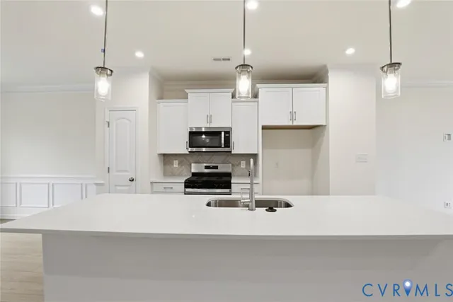 a large kitchen with stainless steel appliances kitchen island granite countertop a stove a sink a refrigerator and a wooden cabinets