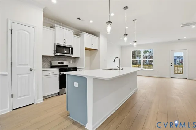 a kitchen with granite countertop a sink and a stove top oven