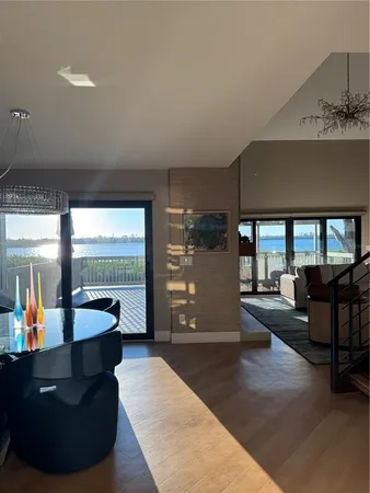 a living room with furniture and large windows