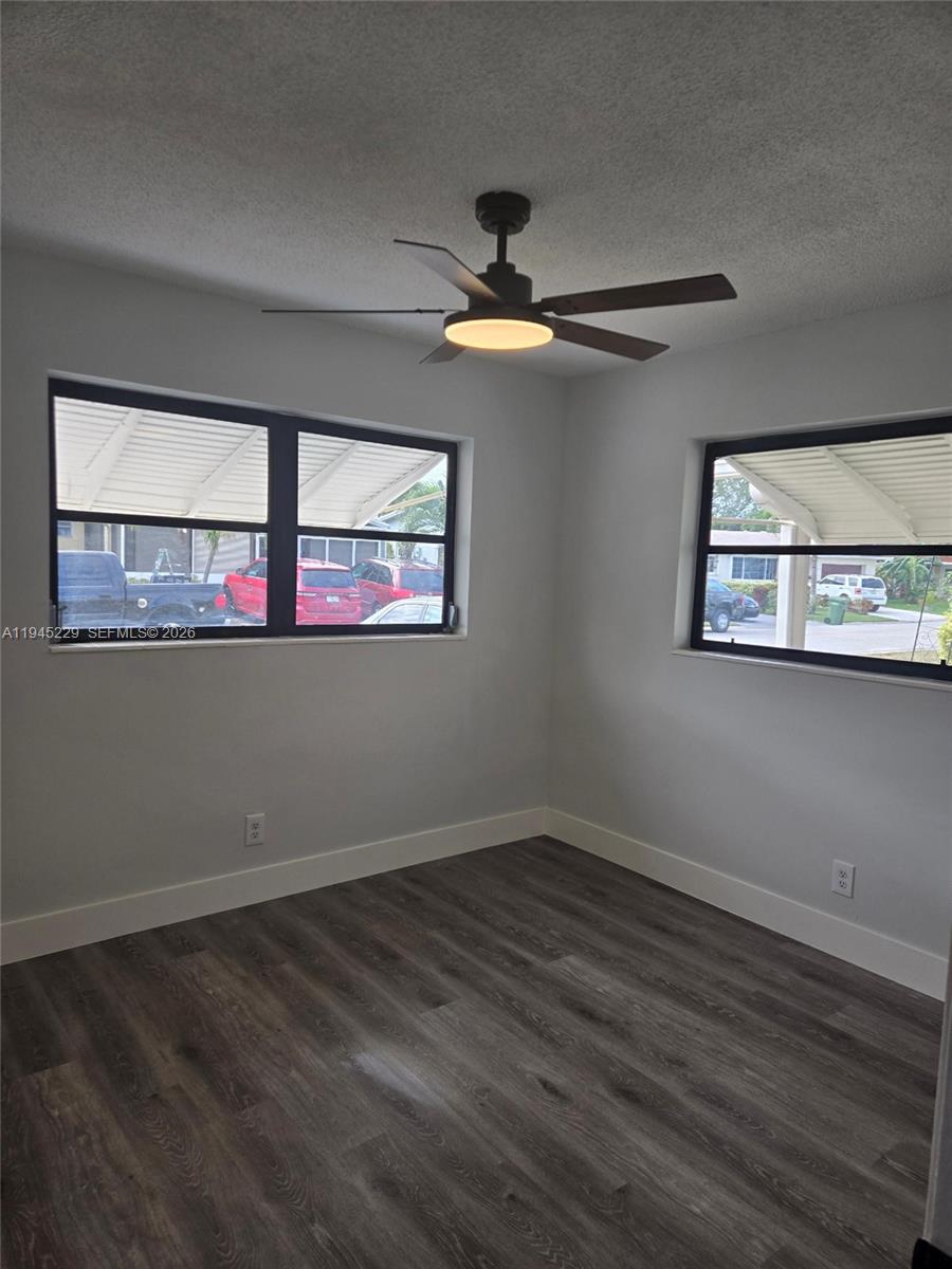 6855 Northwest 9th Street Margate, FL 33063 - Photo 12 of 21 a view of empty room with wooden floor and fan