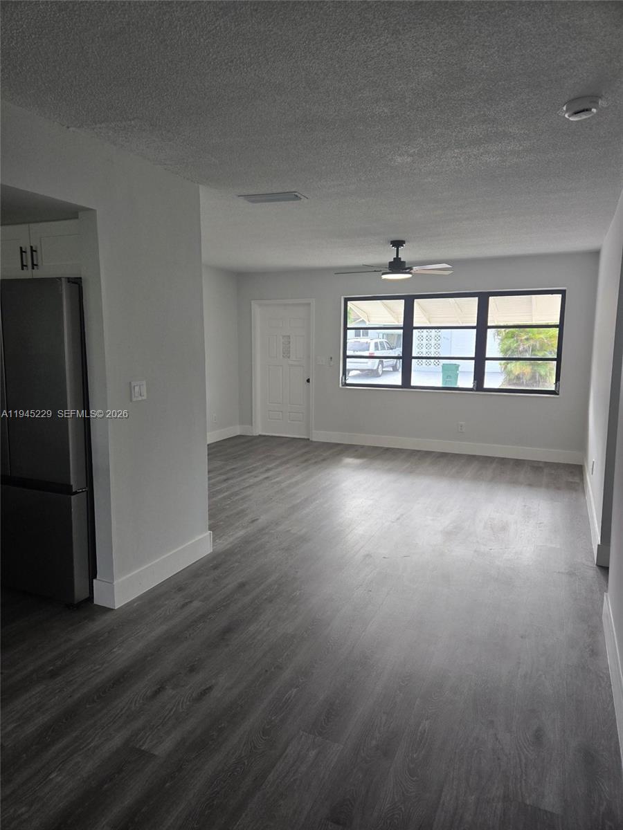 6855 Northwest 9th Street Margate, FL 33063 - Photo 13 of 21 an empty room with wooden floor and windows