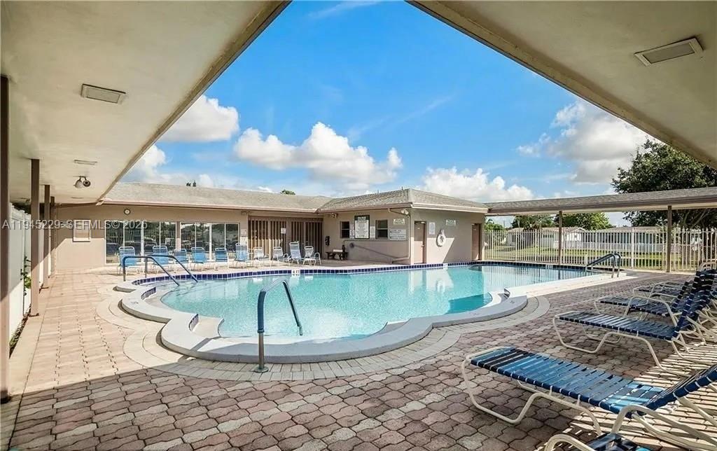 6855 Northwest 9th Street Margate, FL 33063 - Photo 17 of 21 a view of a swimming pool with lounge chair
