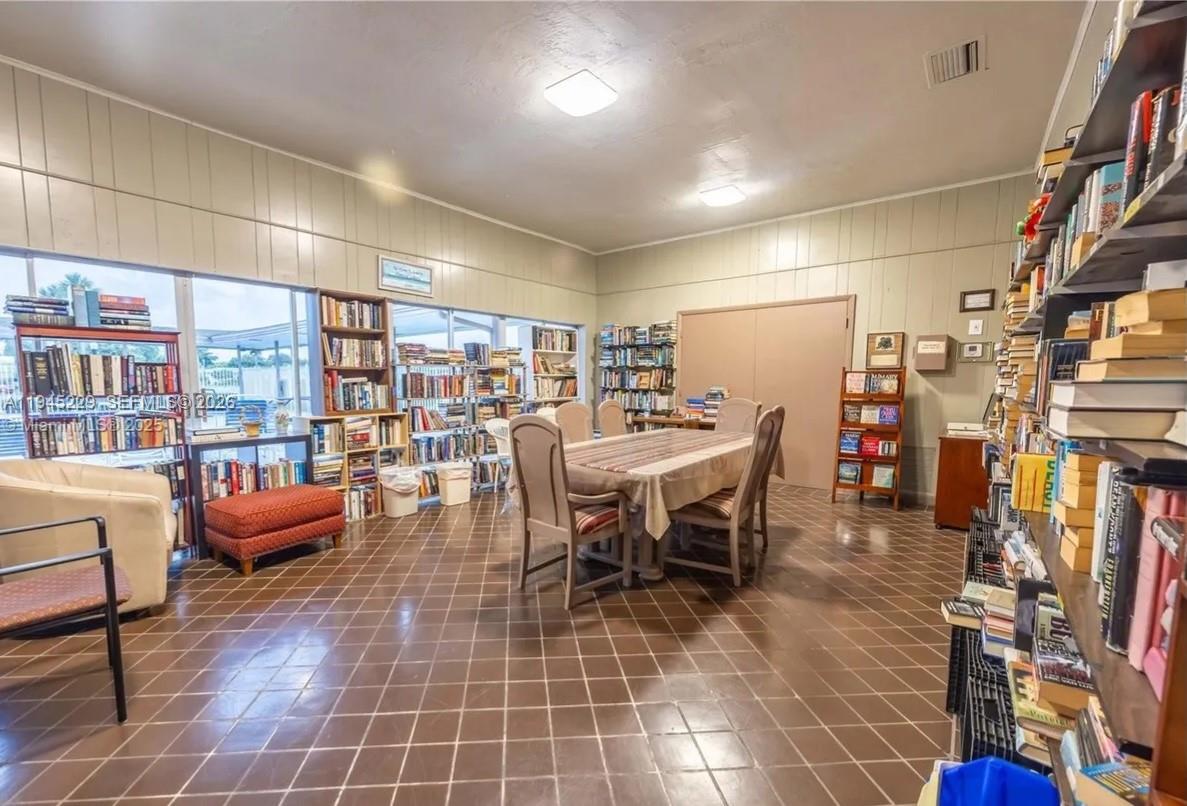 6855 Northwest 9th Street Margate, FL 33063 - Photo 19 of 21 a dining room with furniture and a book shelf
