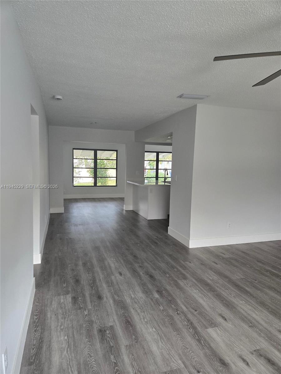 6855 Northwest 9th Street Margate, FL 33063 - Photo 3 of 21 an empty room with wooden floor and windows