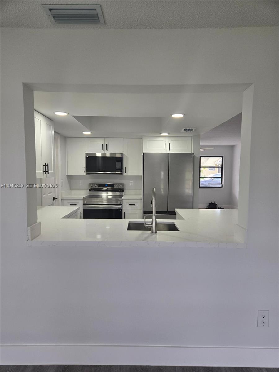 6855 Northwest 9th Street Margate, FL 33063 - Photo 5 of 21 a view of kitchen with refrigerator and stove