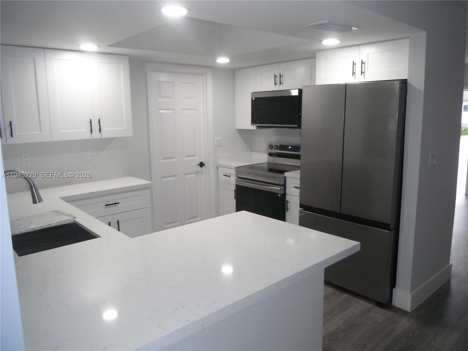 6855 Northwest 9th Street Margate, FL 33063 - Photo 7 of 21 a kitchen with stainless steel appliances a refrigerator sink and microwave