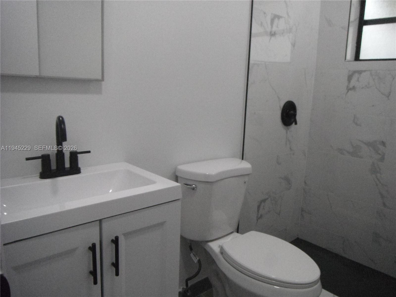 6855 Northwest 9th Street Margate, FL 33063 - Photo 8 of 21 a bathroom with a sink a toilet and vanity