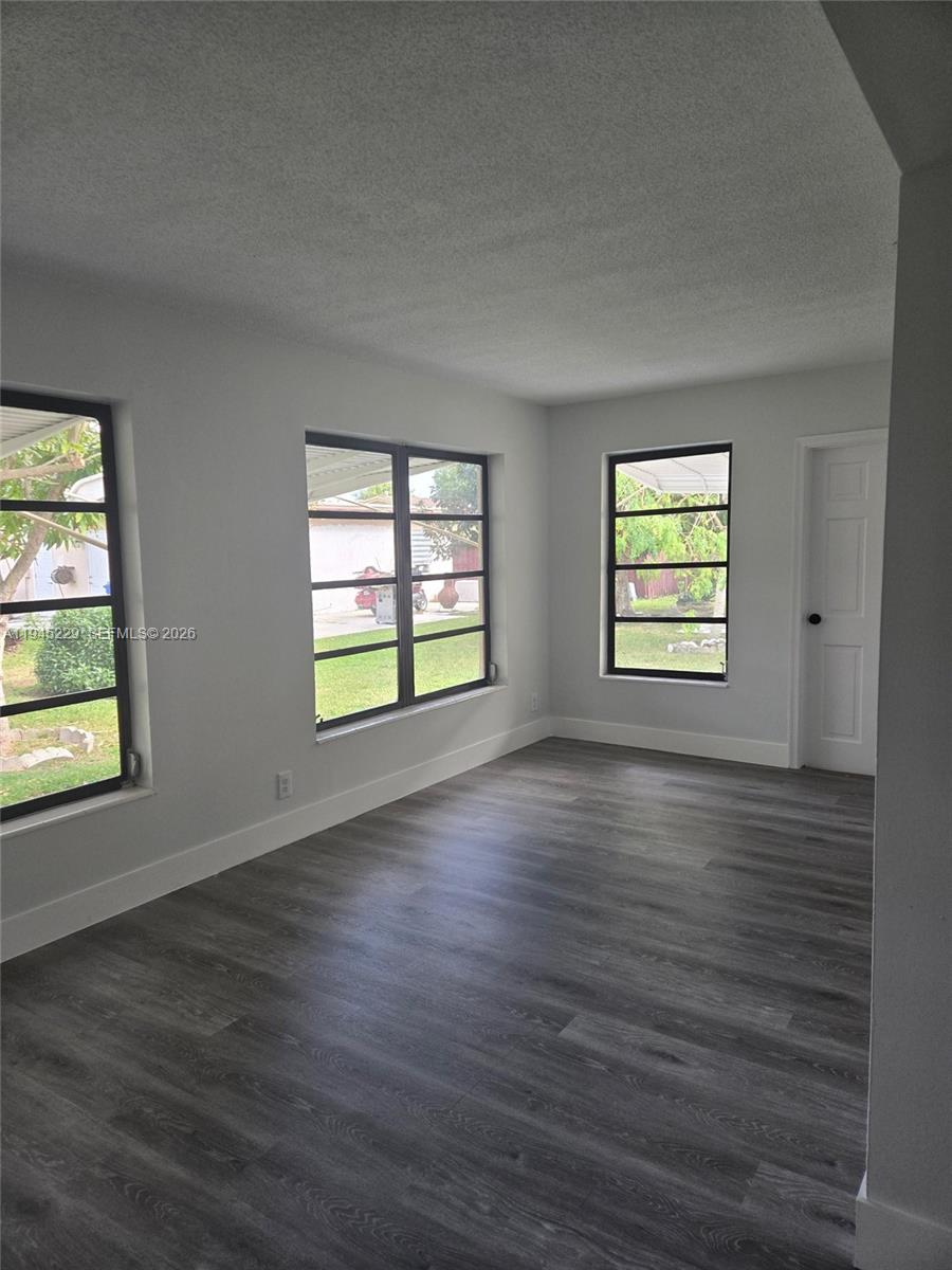 6855 Northwest 9th Street Margate, FL 33063 - Photo 9 of 21 an empty room with wooden floor and windows