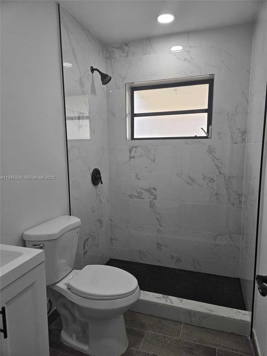 6855 Northwest 9th Street Margate, FL 33063 - Photo 10 of 21 a bathroom with a toilet a sink and a shower