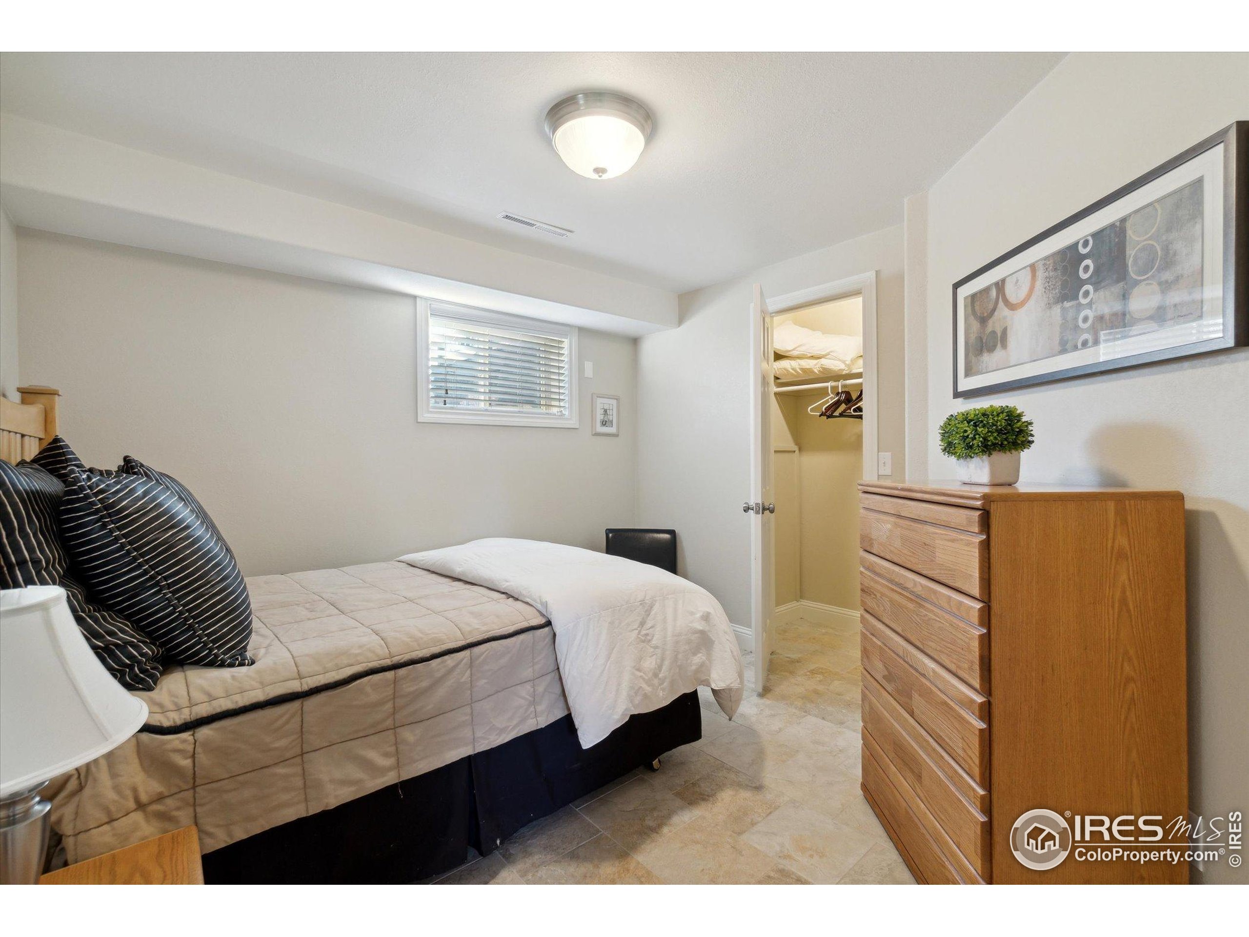 1034 Spring Drive Boulder, CO 80303 - Photo 36 of 49 a bedroom with a bed and a cabinets