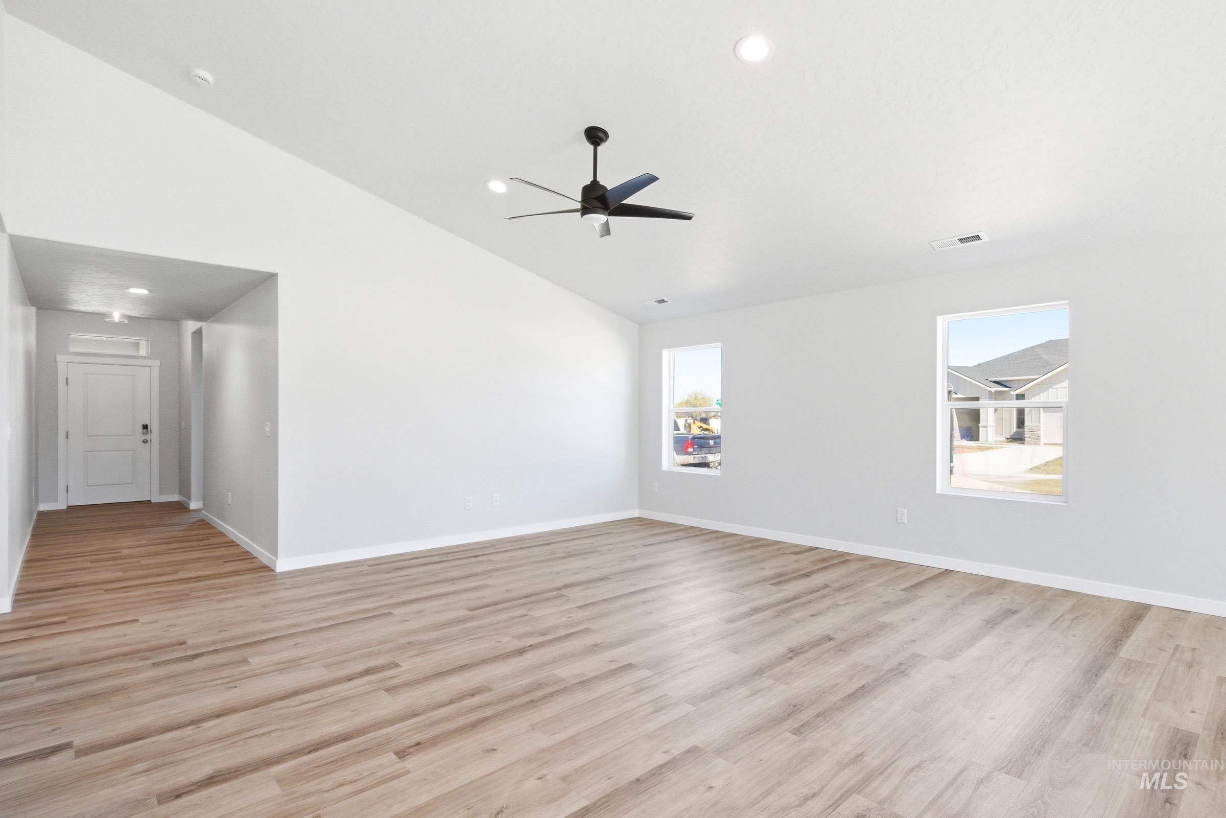 12817 Decatur Street Nampa, ID 83651 - Photo 10 of 19 Spacious living area featuring a vaulted ceiling and wood-finish flooring