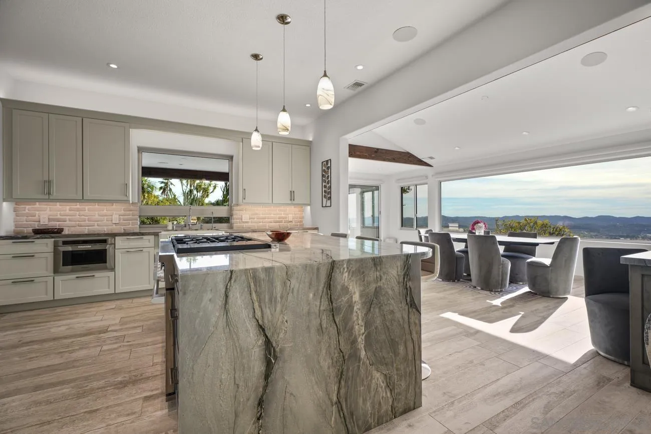 13155 McNally Road Valley Center, CA 92082 - Photo 17 of 69 a large kitchen with lots of counter space and stainless steel appliances