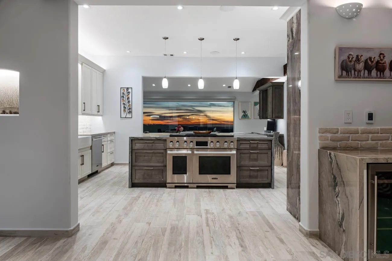 13155 McNally Road Valley Center, CA 92082 - Photo 19 of 69 a kitchen with stainless steel appliances a stove top oven and sink