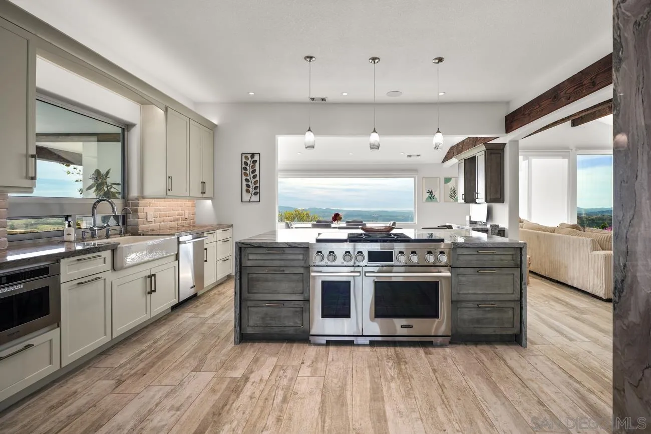 13155 McNally Road Valley Center, CA 92082 - Photo 20 of 69 a kitchen with stainless steel appliances a stove top oven and sink