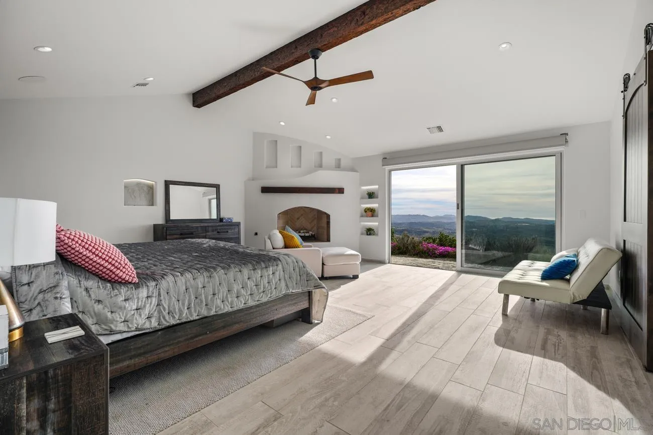 13155 McNally Road Valley Center, CA 92082 - Photo 26 of 69 a living room with furniture large windows and a fireplace