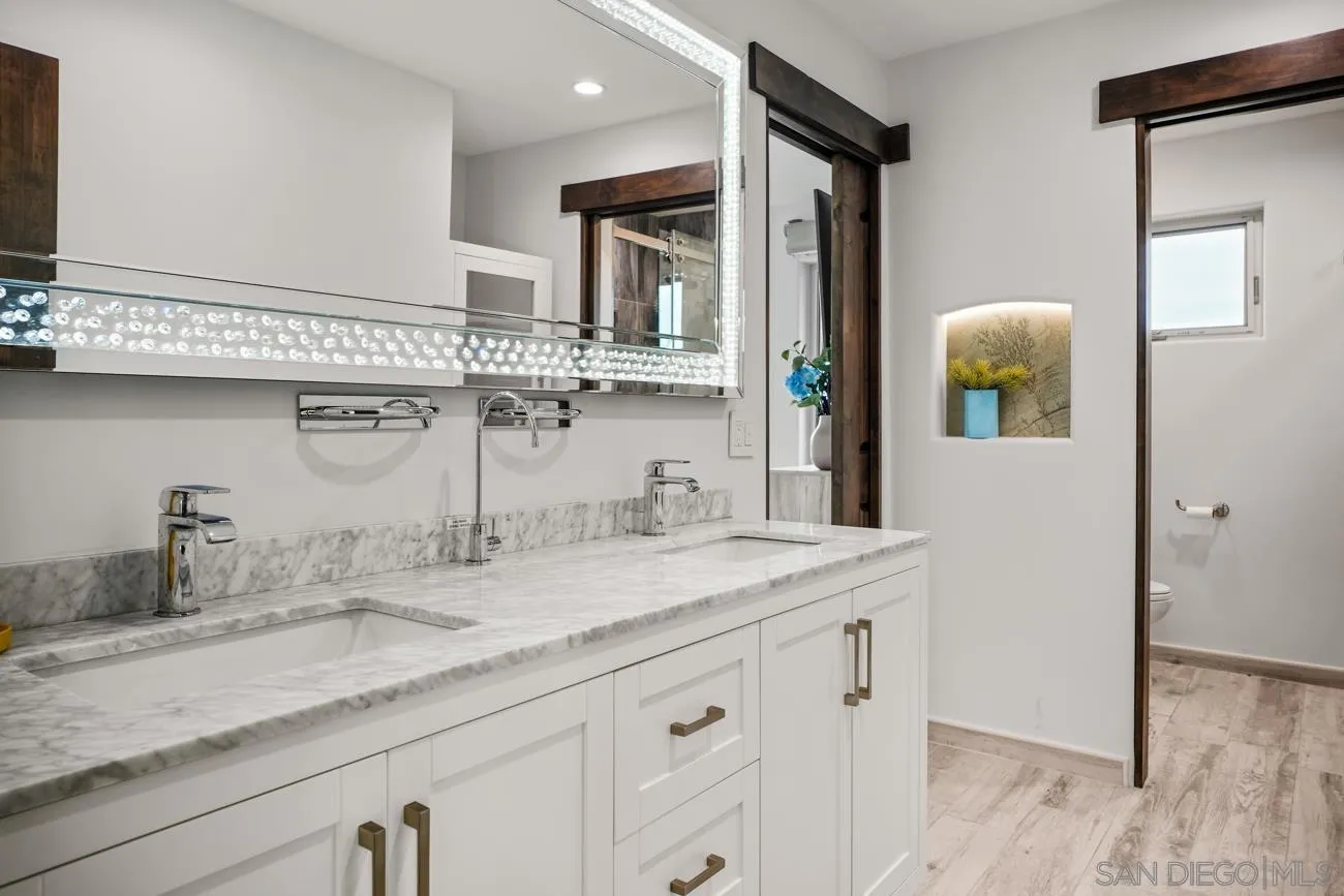 13155 McNally Road Valley Center, CA 92082 - Photo 34 of 69 a bathroom with a granite countertop sink and a mirror
