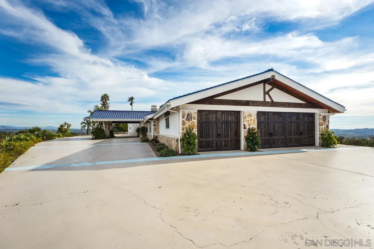 13155 McNally Road Valley Center, CA 92082 - Photo 9 of 69 a front view of a house with a yard and garage