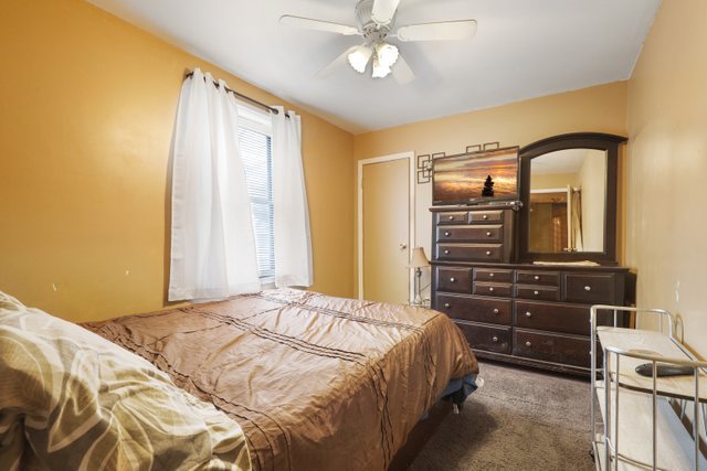 12504 Maple Avenue Blue Island, IL 60406 - Photo 13 of 25 a bedroom with a bed and a dresser