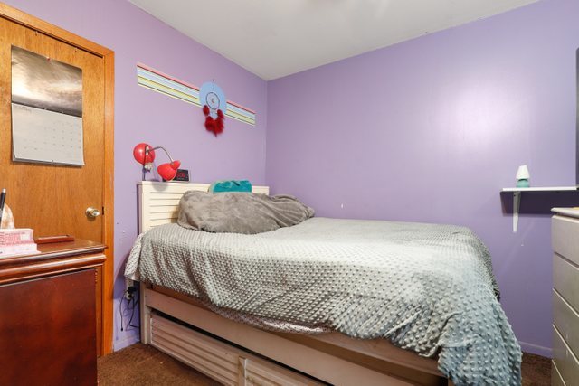 12504 Maple Avenue Blue Island, IL 60406 - Photo 14 of 25 a bedroom with a bed and a dresser
