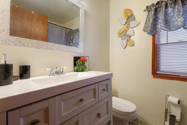 12504 Maple Avenue Blue Island, IL 60406 - Photo 15 of 25 a bathroom with a toilet sink and mirror
