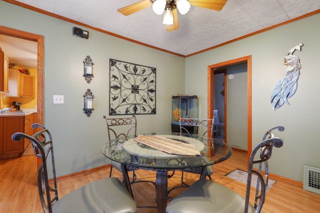 12504 Maple Avenue Blue Island, IL 60406 - Photo 8 of 25 a view of a dining room with furniture and wooden floor