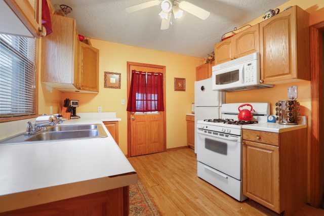 12504 Maple Avenue Blue Island, IL 60406 - Photo 9 of 25 a kitchen with stainless steel appliances granite countertop a sink stove and refrigerator