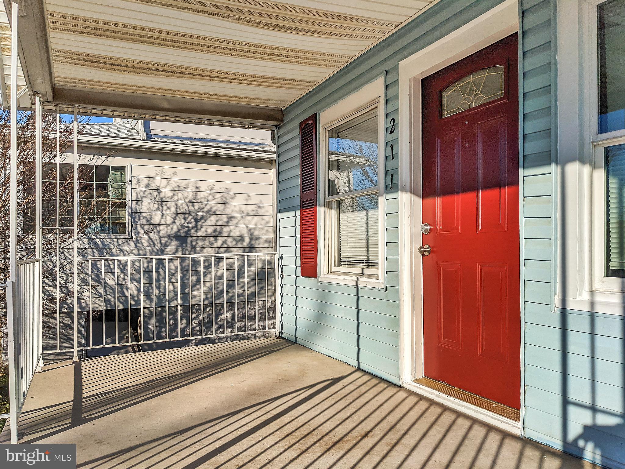 211 Main Street Dundalk, MD 21222 - Photo 22 of 22 Charming entryway with vibrant red door.