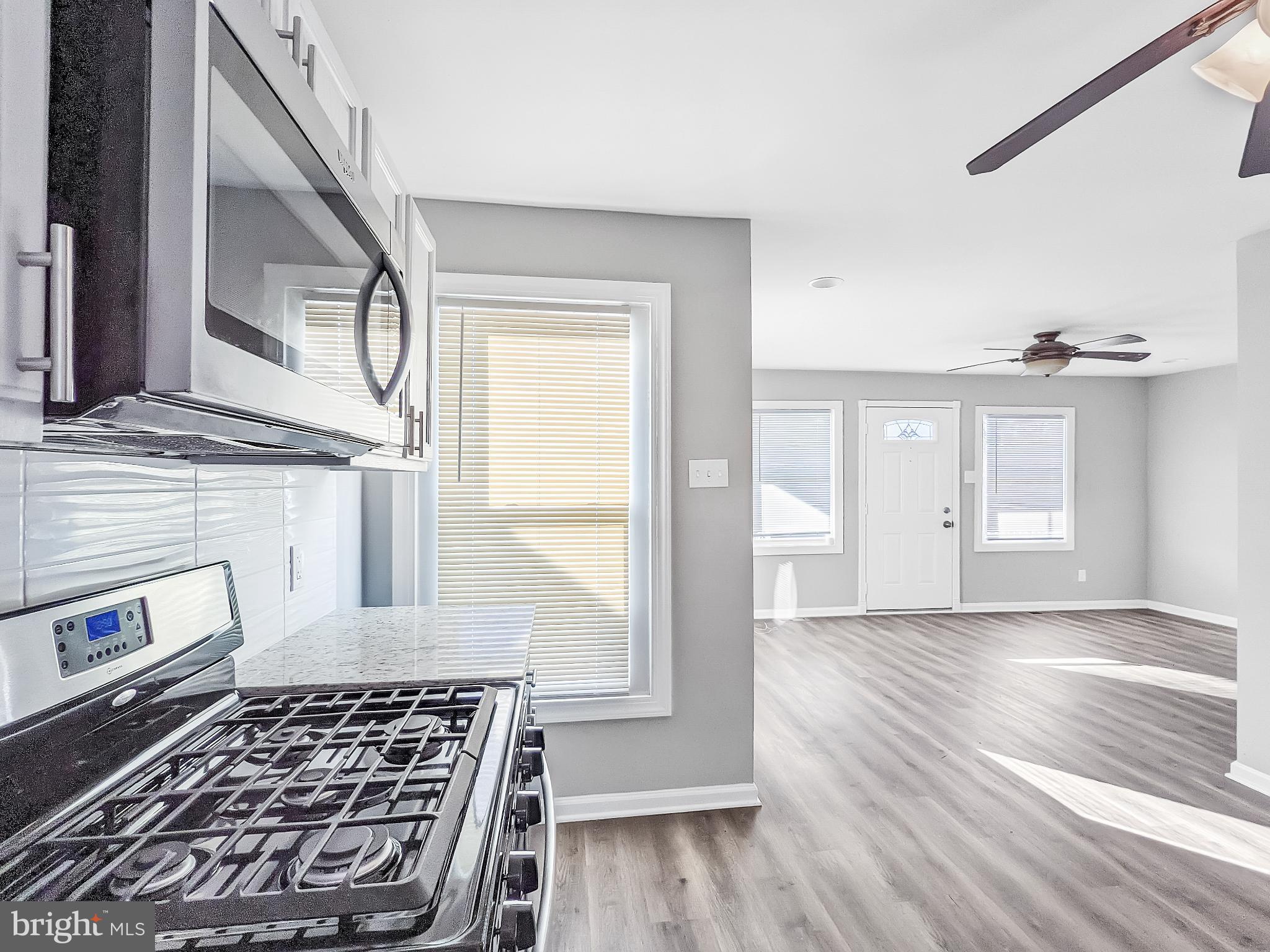 211 Main Street Dundalk, MD 21222 - Photo 7 of 22 Modern kitchen meets airy living space.