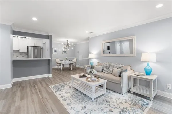 a living room with furniture and view of kitchen