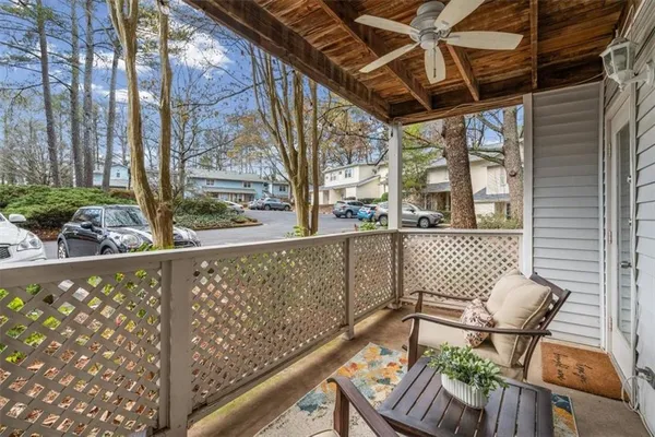 a view of balcony with wooden floor and outdoor seating