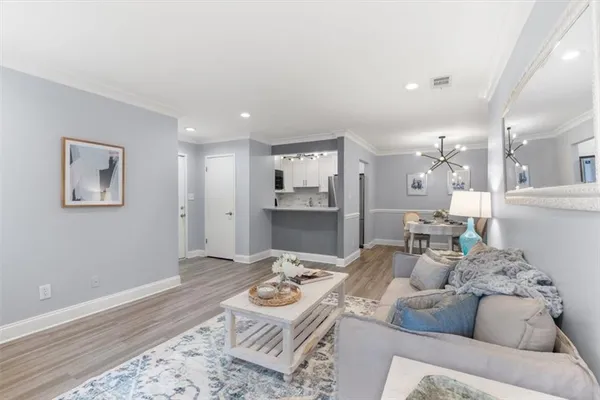a living room with furniture and wooden floor