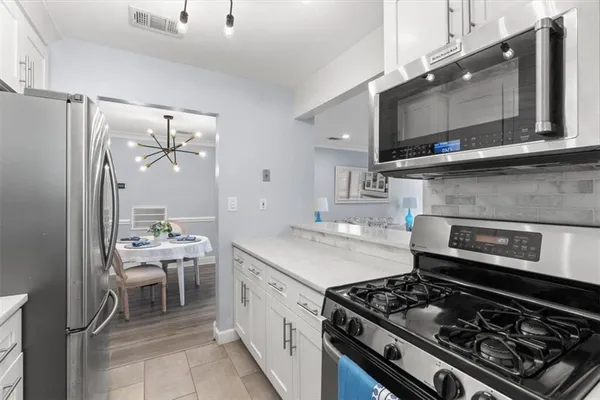 a kitchen with a stove and a microwave