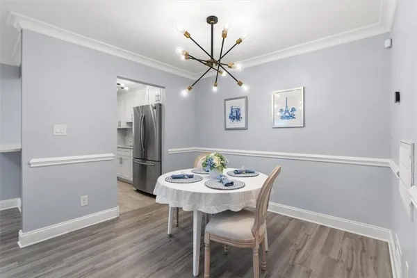 a view of a dining room with furniture wooden floor and a chandelier