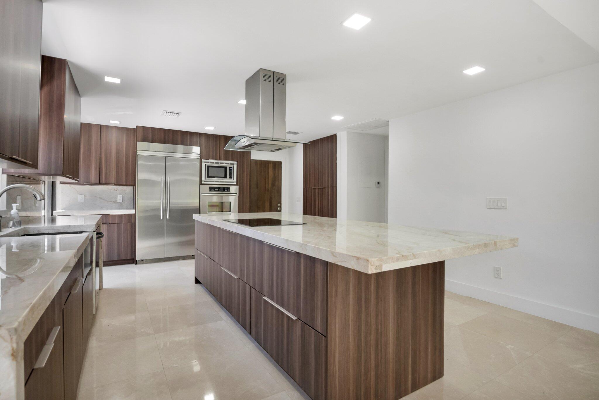 a kitchen with stainless steel appliances a sink and a refrigerator