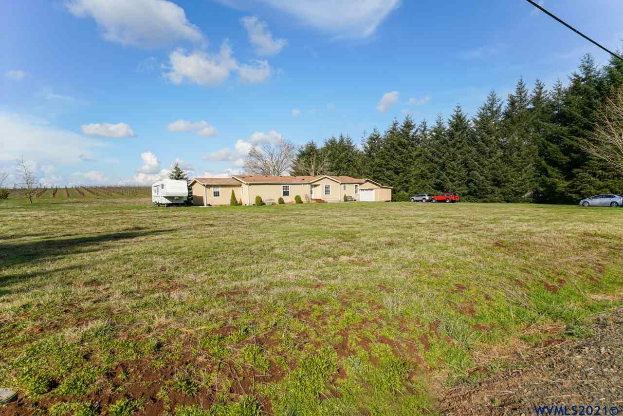 153 Hylo Road Southeast Salem, OR 97306 - Photo 4 of 41 a view of a field with an trees in the background