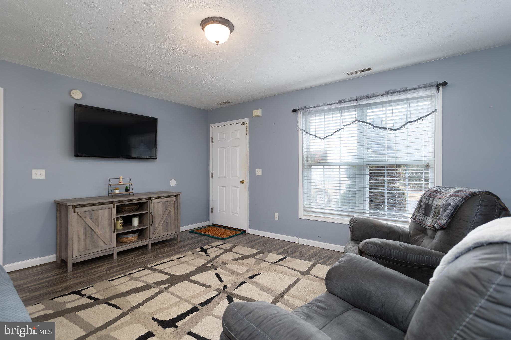 1303 Colonial Avenue Cambridge, MD 21613 - Photo 3 of 12 a living room with furniture and a flat screen tv