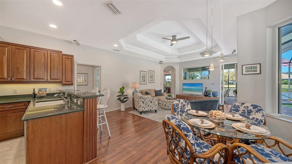 665 Crane Prairie Way Osprey, FL 34229 - Photo 15 of 61 a view of a dining room with furniture window and wooden floor