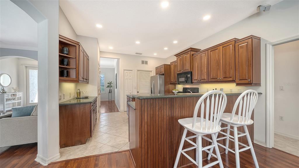 665 Crane Prairie Way Osprey, FL 34229 - Photo 16 of 61 a view of kitchen with wooden floor and seating